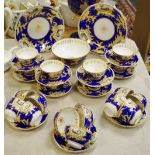 A 19th century hand painted tea service, decorated with landscape panels, gilt ,blue,