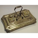 A Victorian silverplated standish, canted rectangular base, two clear glass inkwells,