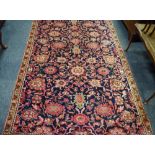 A hand woven Hamadan carpet, floral designs in tones of pink,