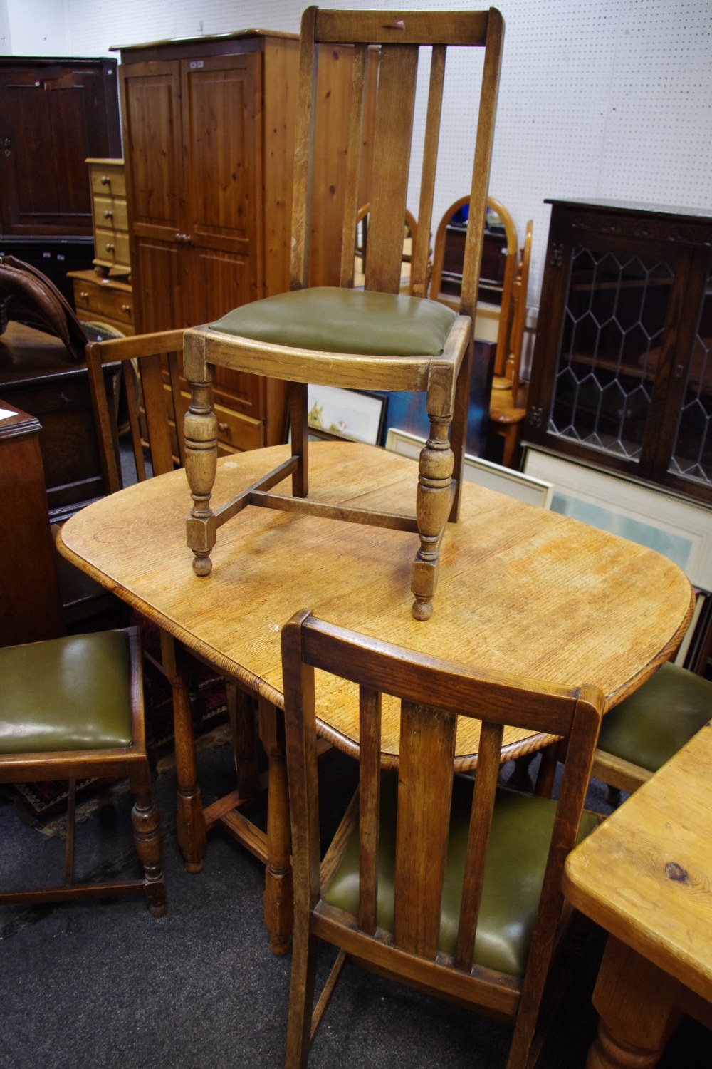 An early 20th century oak gateleg dining table;