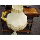 A substantial alabaster lamp base; reproduction tooled leather inlaid occasional table;