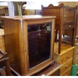 An early 20th century mahogany cabinet, crossbanded top, glazed door, bun feet,