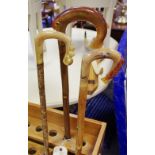 Rams horn walking sticks - a trout market stick; a crook with leaping salmon and bird decoration;