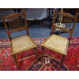 A pair of late Victorian bedroom chairs, spindle back, cane work seat,