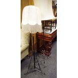 A wrought iron telescopic standard lamp; another wrought iron.