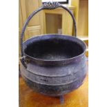 A cast iron three legged cauldron circa 1900.
