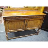 An early 20th century oak sideboard, moulded frieze, shaped fielded panel doors,