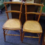 A pair of Edwardian cane seated bedroom chairs,