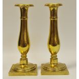 A pair of brass George III slender baluster shaped candlesticks