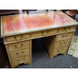 A stripped mahogany kneehole desk, leather inlaid top,