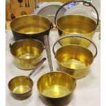 A brass jam pan, three others two smaller; a brass saucepan,