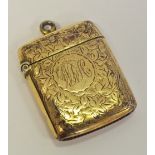 An Edwardian silver-gilt vesta case, engraved with scrolling foliage,