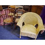 An elm spindle back chair, shaped top rail, outswept arms, spindled supports, circular seat,