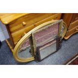 A mahogany Vauxhall type mirror; an oval gilt framed wall mirror; another,