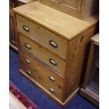 A pine chest of four drawers, brass cup handles. 82cm high x 65cm wide x 63cm deep.