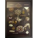 Two wall hanging display boxes containing various brooches including a Victorian 9ct gold bar