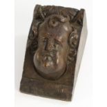 A 17th century walnut sculptural architectural fragment, carved with a putto mask, 12cm x 7.5cm, c.