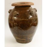 A large Chinese monochrome ovoid wine jar, in the Ming Manner, moulded with lion masks,