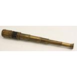 A 19th century brass six-draw pocket telescope, leather grip, sliding aperture cover to eyepiece,