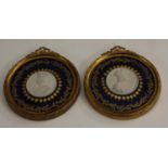 A pair of 19th century French gilt metal mounted porcelain portrait roundels,