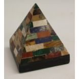 A pietra dura desk pyramid, inlaid with rows of alternating specimen stones,