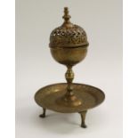 An Islamic brass incense burner, the globular censer with knop finial and pierced cover,