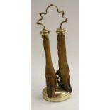 A 19th century brass and taxidermy door porterm shaped carrying handle above two deer hooves and