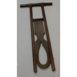A Victorian country house pitch pine boot jack, of typical folding farm, joined T-bar handle,
