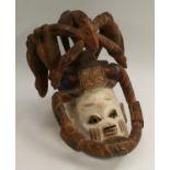 Tribal Art - a Yoruba gelede mask, of typical helmet form, the domed features crested by a horse,