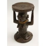 Tribal Art - a Luba stool or headrest, carved as a kneeling female caryatid, an infant on her back,