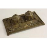 A Renaissance Revival bronze inkstand, twin-wells with hinged covers, cast throughout with acanthus,