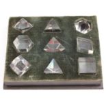 An interesting set of nine clear glass sample prisms, of various forms and refractions,