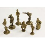 A collection of 19th century brass pipe tampers, cast as Dickensian figures,