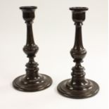 Treen - a pair of 19th century turned lignum vitae table candlesticks, 26.5cm high, c.