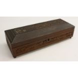 An Indian sandalwood rectangular box, carved in relief with buildings, animals and dense foliage,