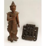 A Burmese hardwood figure, carved as a deity, 49cm high, early 20th century; an Indian panel,