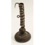 Treen - a primitive iron spiral candlestick, rudimentary ejector, circular base, 21.
