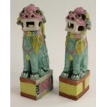 A pair of Chinese models of temple lions, decorated in polychrome enamels, 22cm high,