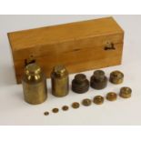 A set of thirteen brass scientific balance/scale weights, 1 Kilo to 9m, fitted beech cas, 25.