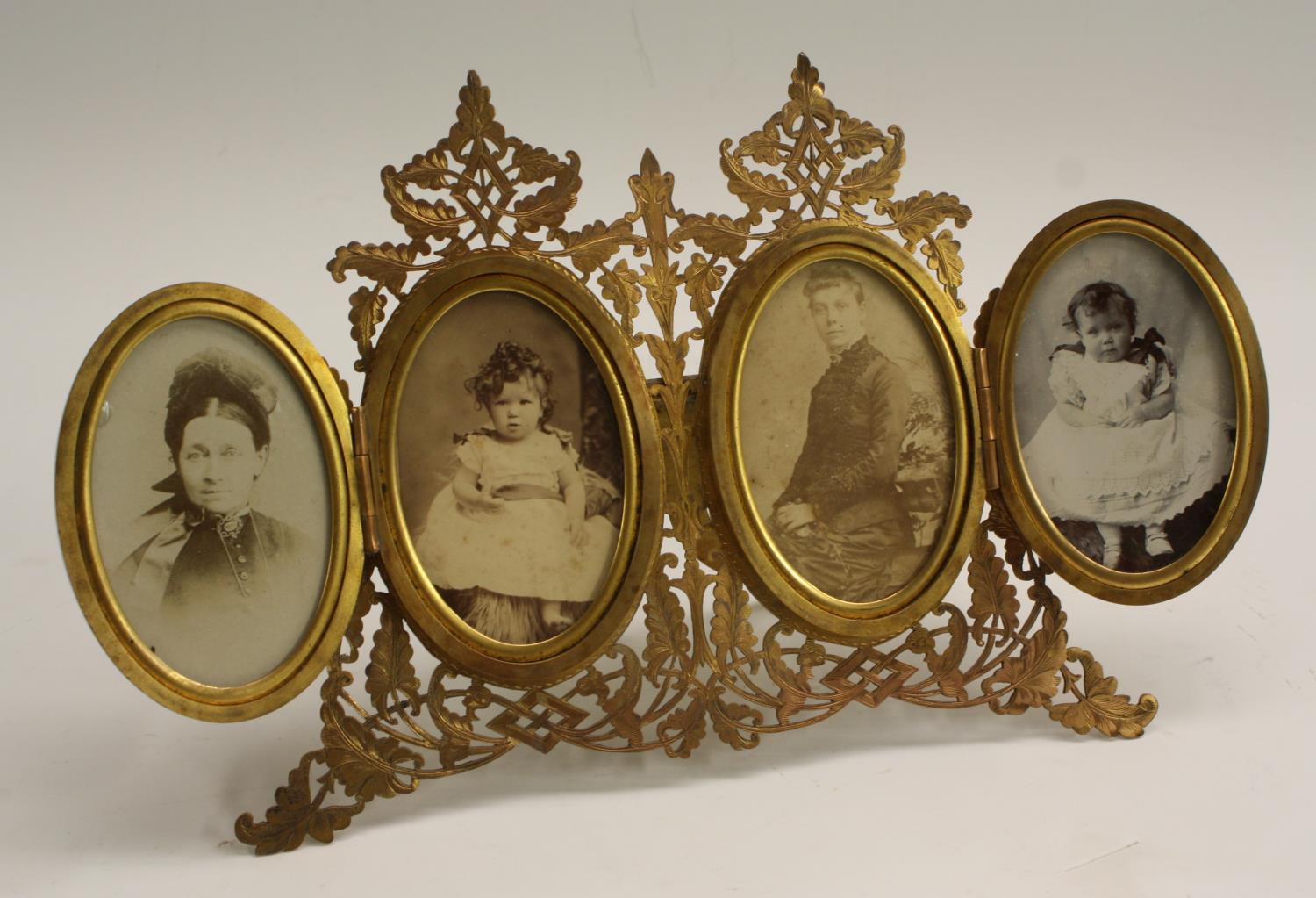 A 19th century gilt tetraptych easel photograph frame, pierced and engraved with scrolling ferns,