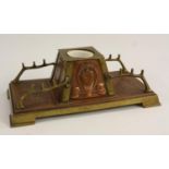 An Arts and Crafts copper and brass desk stand,