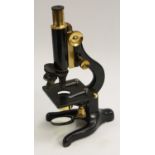 A lacquered brass and black painted Y-stand monocular microscope, Kima, by W Watson & Sons Ltd,
