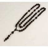 A set of French hardwood rosary beads, the heart shaped pendant stamped Souvenir de nd de Lourdes,