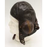 An Air Ministry issue brown leather flying helmet, chamois lining stamped A.I.D 6.T.