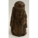 A Chinese bamboo figure, carved as an immortal holding a ripe peach,