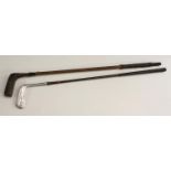 Golf Clubs - an early 20th century putter, brass sole, weaighted ebonised head, hickory shaft,
