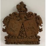 A 19th century oak armorial, carved with arms coat of arms and motto Veritas Vincit Spes Mea in Deo,