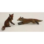 An Austrian cold painted bronze, of a fox, on the run, 12cm long; another, seated,