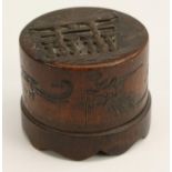 A Japanese bamboo cylindrical box and cover, the push-fitting cover carved with a torii gate,