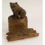 A Black Forest novelty desk stand, carved as a bear seated on a tree trunk,
